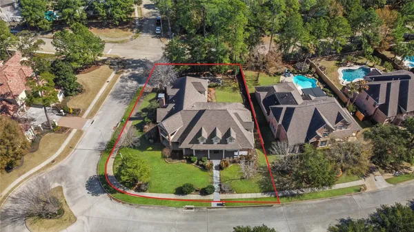 an aerial view of a house with a garden and swimming pool