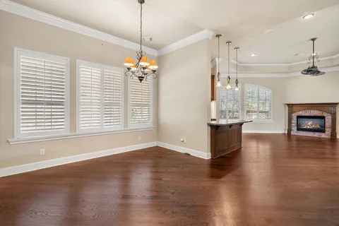an aerial view of lake and residential houses with outdoor space