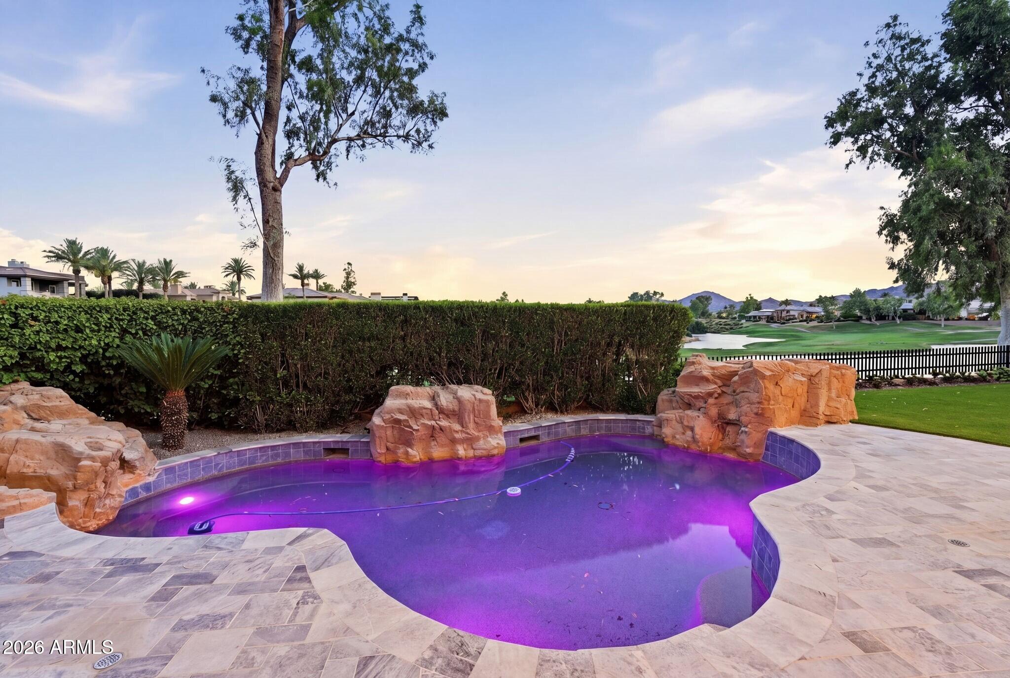 7475 East Gainey Ranch Road, Unit 7 Scottsdale, AZ 85258 - Photo 67 of 77 a view of a swimming pool in the backyard of a house