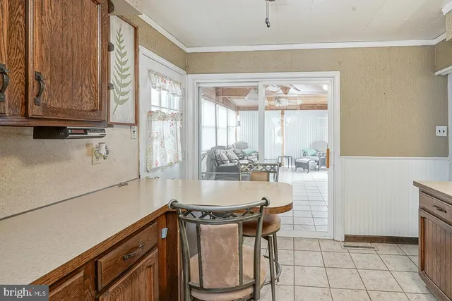 a dining room with furniture and large windows