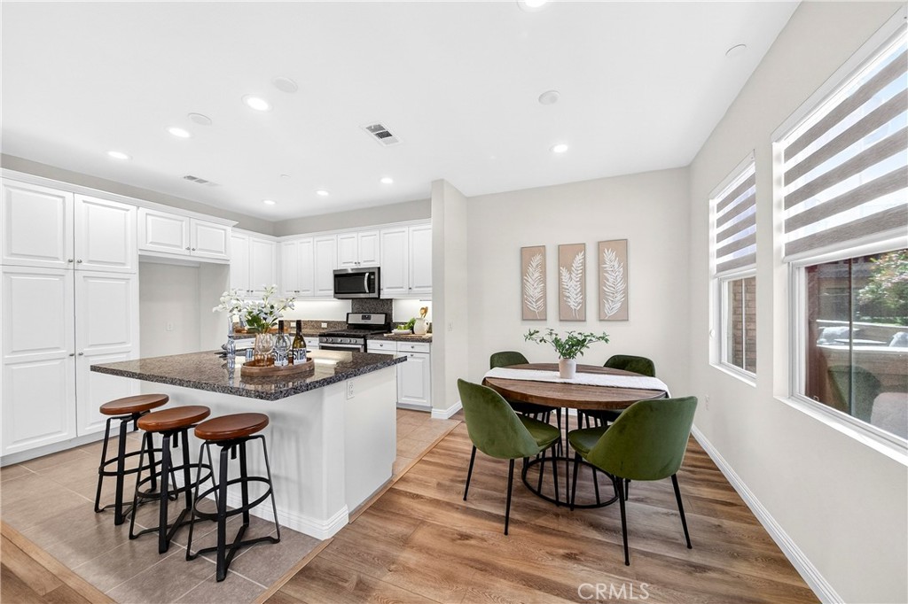 341 Adalina Lane Brea, CA 92821 - Photo 24 of 60 a kitchen with stainless steel appliances kitchen island granite countertop a sink and a table