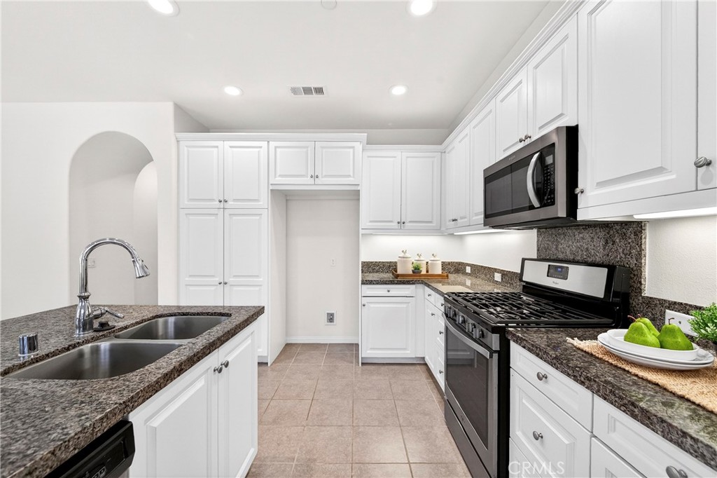 341 Adalina Lane Brea, CA 92821 - Photo 29 of 60 a kitchen with granite countertop a sink stainless steel appliances and cabinets