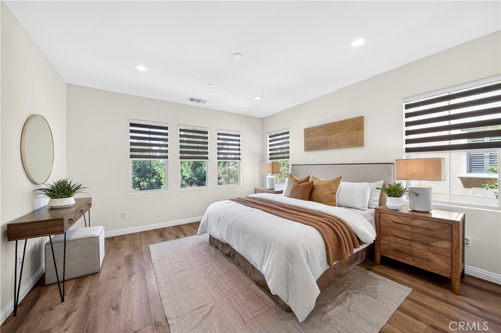341 Adalina Lane Brea, CA 92821 - Photo 44 of 60 a spacious bedroom with a bed a dresser and wooden floor