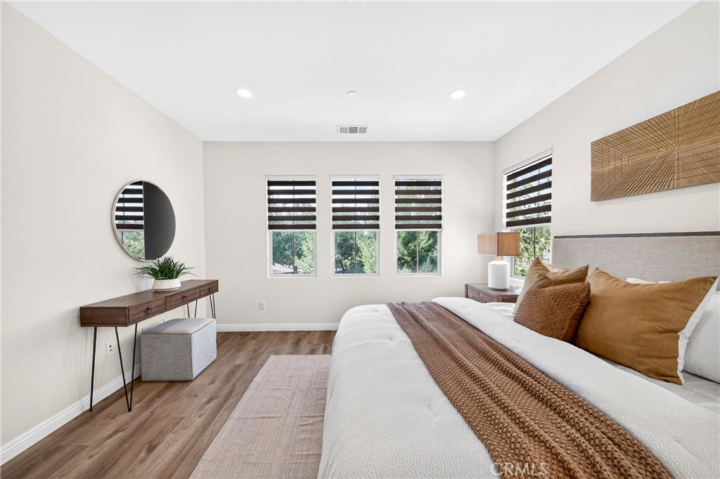 341 Adalina Lane Brea, CA 92821 - Photo 47 of 60 a spacious bedroom with a bed a couch and a window