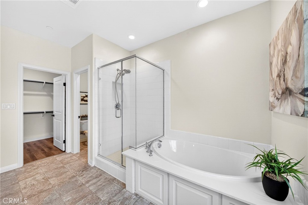 341 Adalina Lane Brea, CA 92821 - Photo 53 of 60 a spacious bathroom with a granite countertop sink a mirror and a bathtub