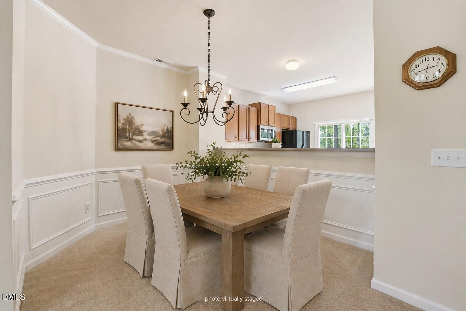 903 Straywhite Avenue Apex, NC 27539 - Photo 15 of 37 a view of a dining room with furniture and a chandelier