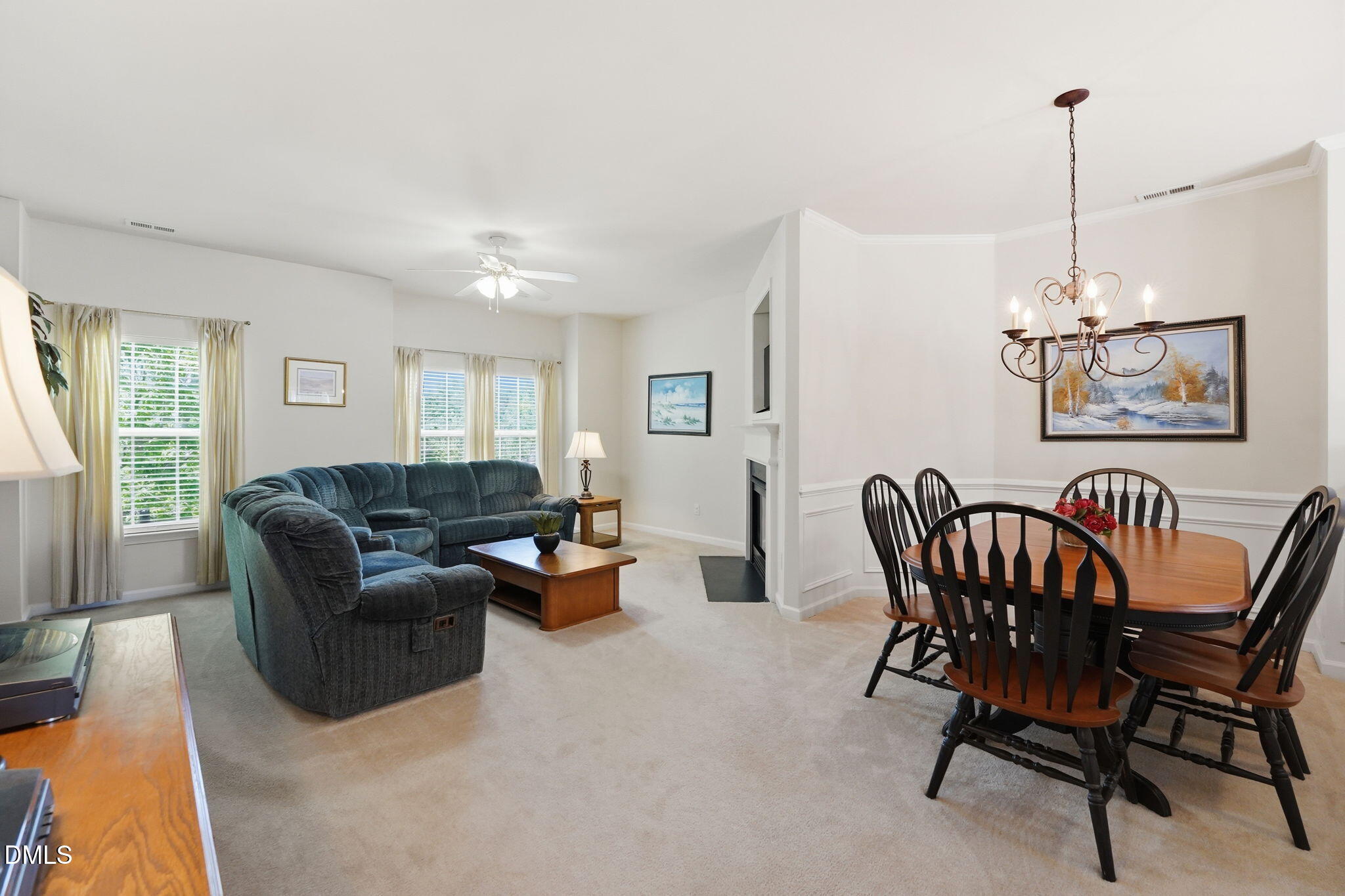 903 Straywhite Avenue Apex, NC 27539 - Photo 16 of 37 a living room with furniture wooden floor and a chandelier