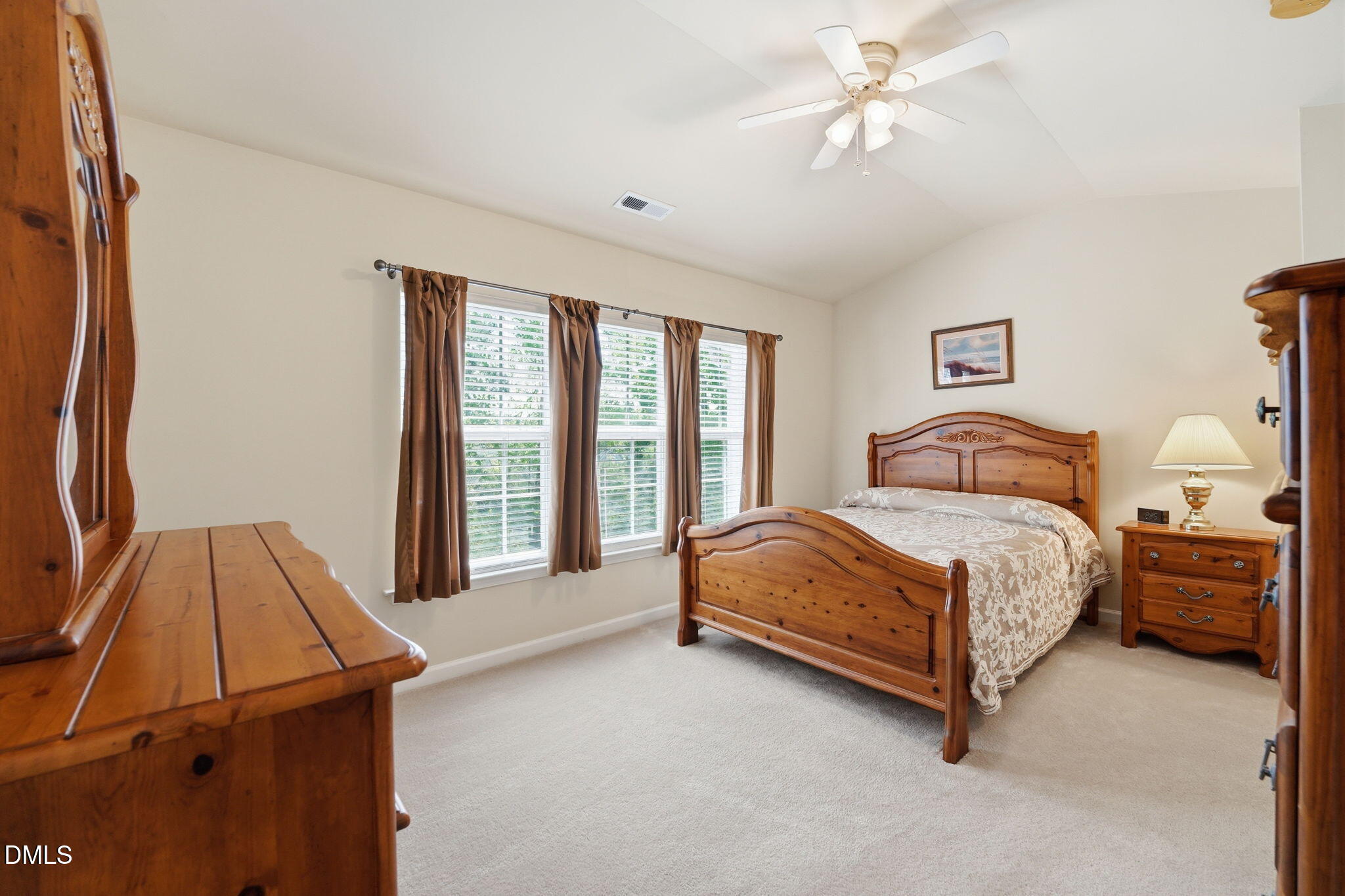 903 Straywhite Avenue Apex, NC 27539 - Photo 20 of 37 a spacious bedroom with a bed and a chandelier