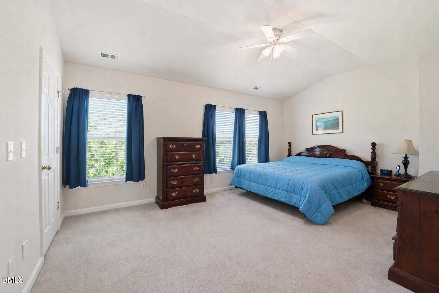903 Straywhite Avenue Apex, NC 27539 - Photo 23 of 37 a spacious bedroom with a bed and a chandelier