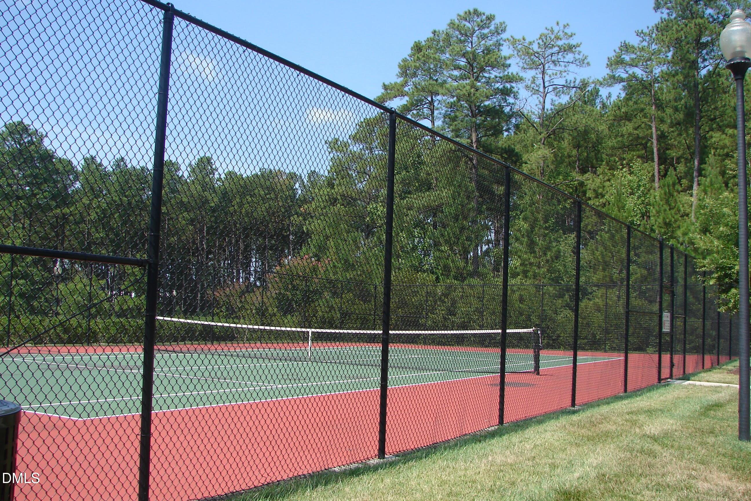 903 Straywhite Avenue Apex, NC 27539 - Photo 32 of 37 a view of a tennis court with a small garden