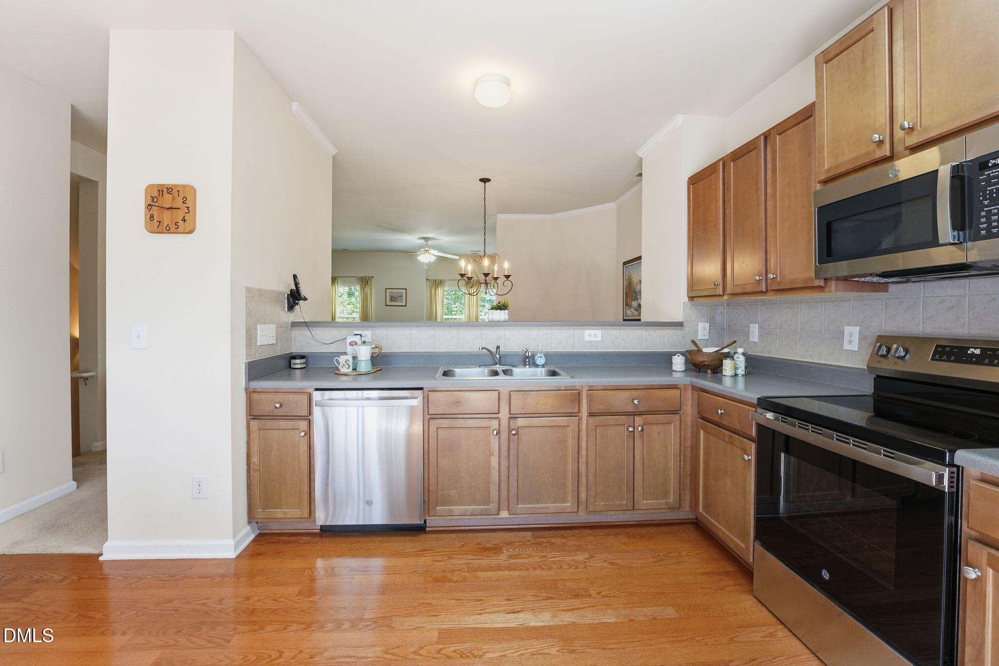 903 Straywhite Avenue Apex, NC 27539 - Photo 4 of 37 a kitchen with stainless steel appliances granite countertop a stove a sink and a microwave