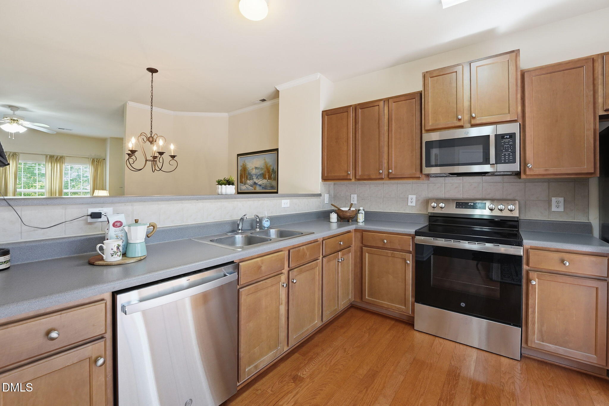 903 Straywhite Avenue Apex, NC 27539 - Photo 5 of 37 a kitchen with granite countertop a sink stove and microwave