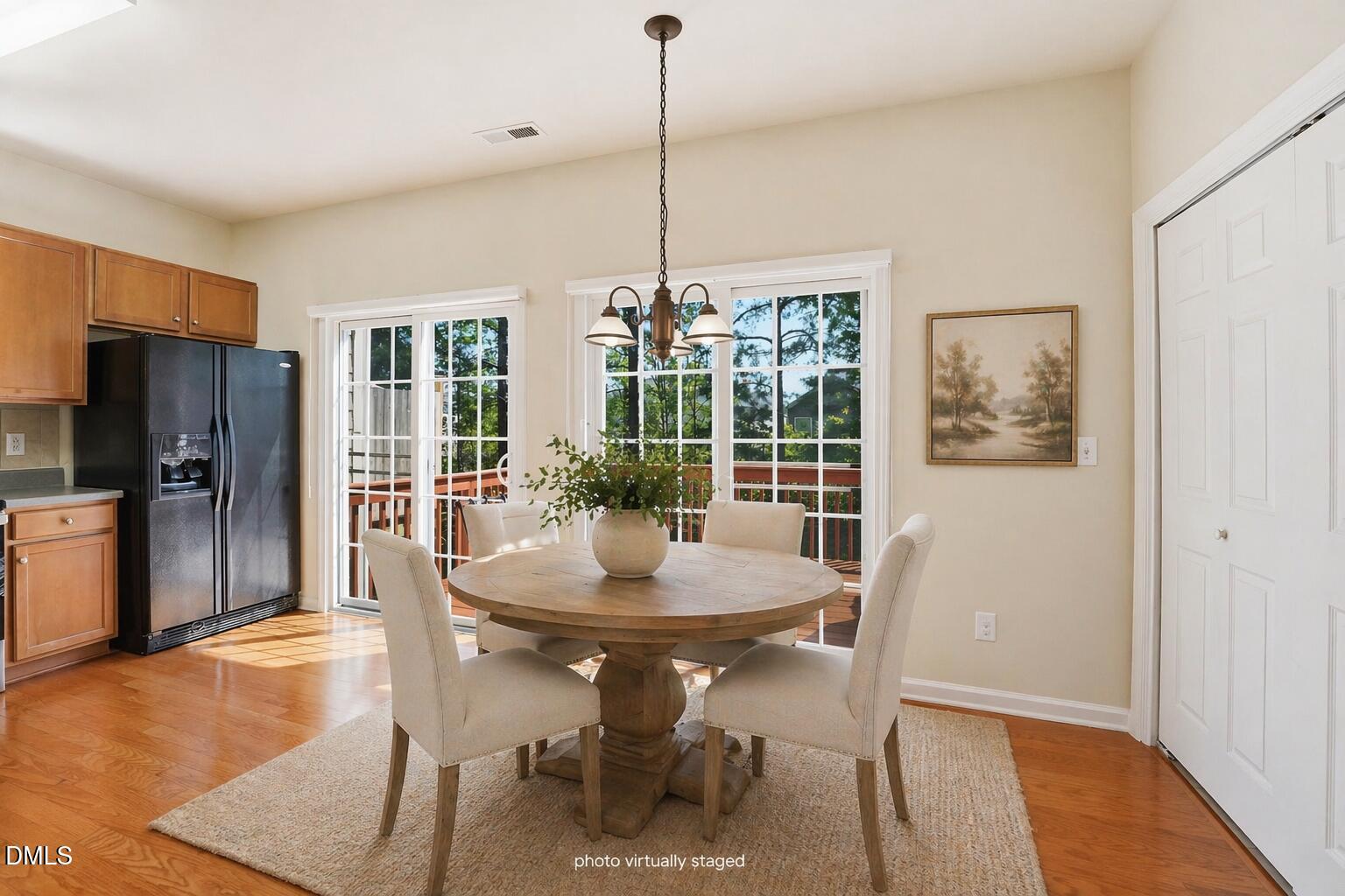 903 Straywhite Avenue Apex, NC 27539 - Photo 8 of 37 a dining room with furniture a chandelier and wooden floor