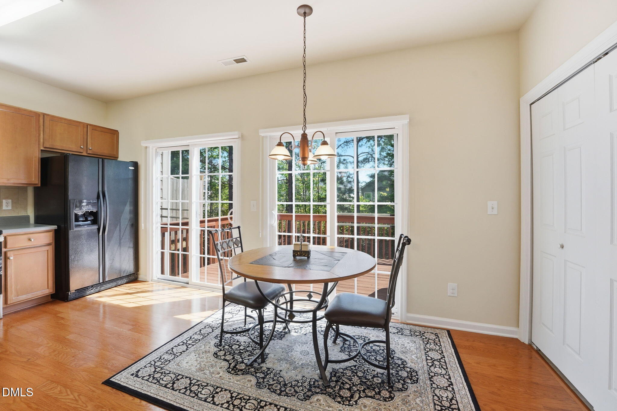 903 Straywhite Avenue Apex, NC 27539 - Photo 9 of 37 a dining room with furniture a rug and wooden floor