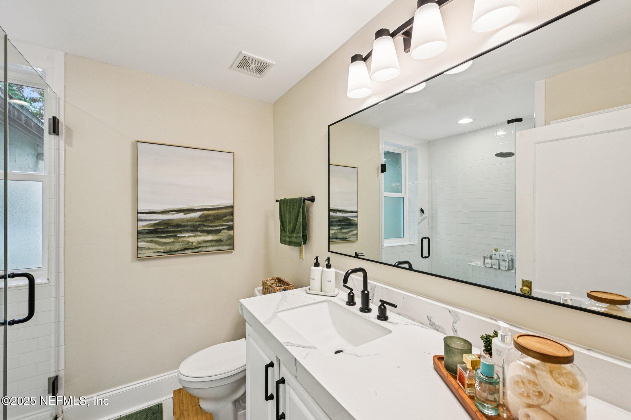 113 Seminole Road Atlantic Beach, FL 32233 - Photo 22 of 52 a bathroom with a sink a toilet and a mirror