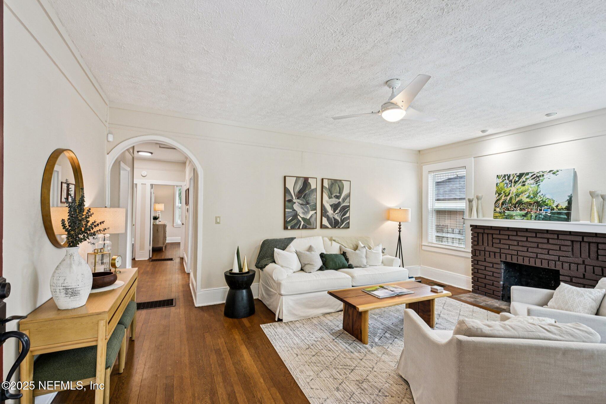 113 Seminole Road Atlantic Beach, FL 32233 - Photo 6 of 52 a living room with furniture a fireplace and wooden floor