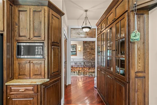 a view of a swimming pool with lawn chairs under an umbrella