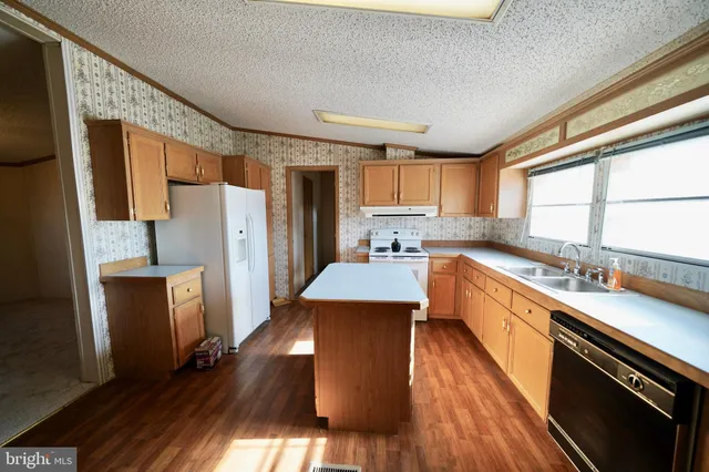 a kitchen with stainless steel appliances a refrigerator sink and cabinets