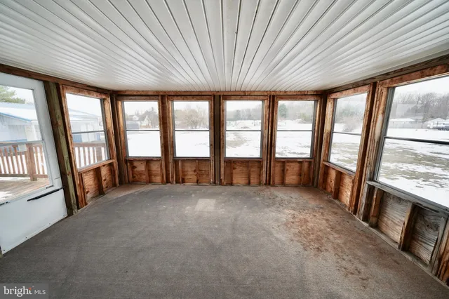 an empty room with large windows