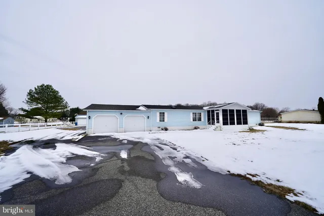 a view of a house with wooden fence