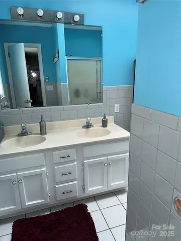 a bathroom with a sink vanity and a mirror