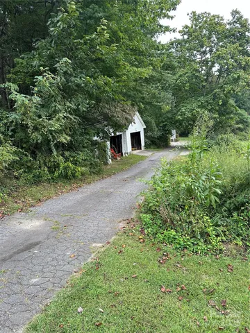 a front view of a house with yard and trees