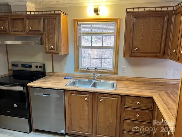 a kitchen with a sink cabinets and window