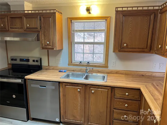 a kitchen with a sink cabinets and window