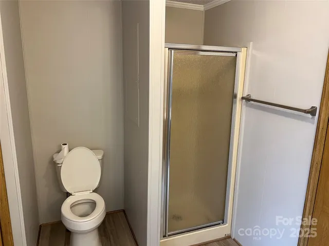 a bathroom with a toilet and a shower