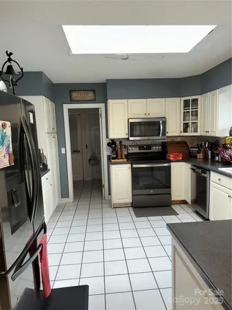 a kitchen with stainless steel appliances a stove a sink and a microwave