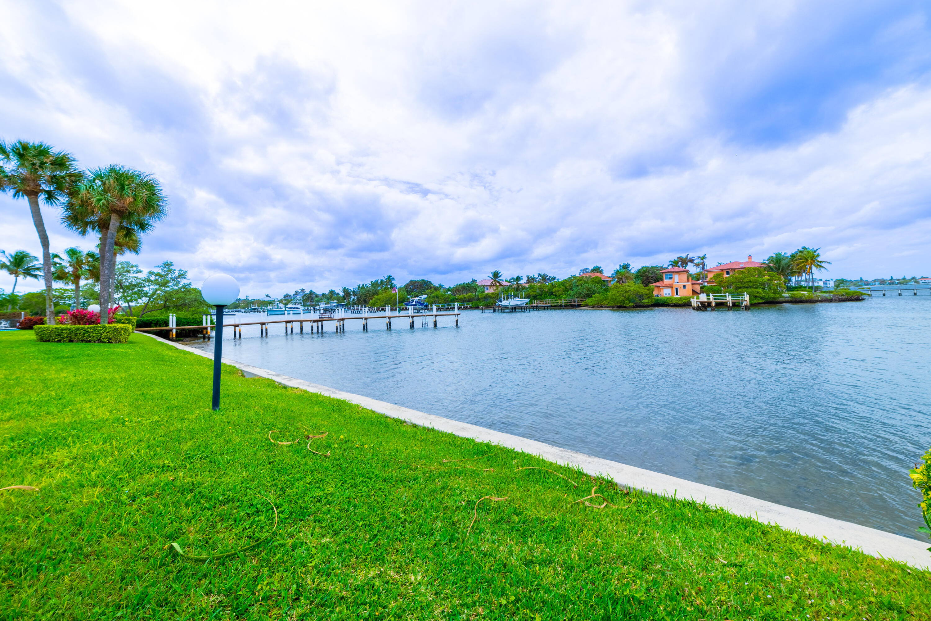 3474 South Ocean Boulevard, Unit 2 Palm Beach, FL 33480 - Photo 1 of 37 a view of a lake with a big yard and a large trees