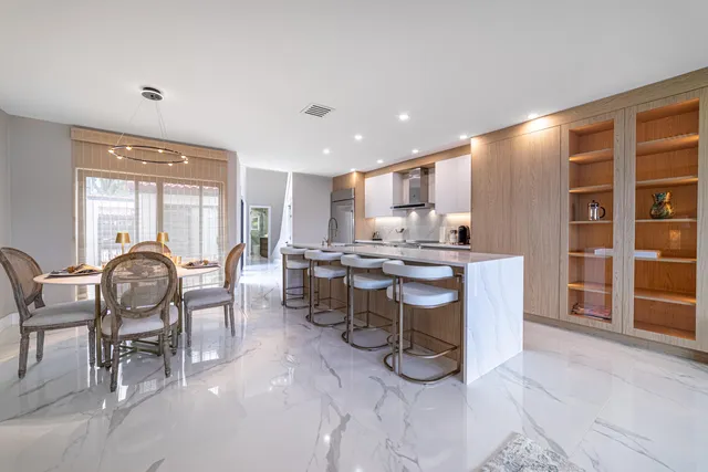 a bathroom with a granite countertop sink a toilet and shower
