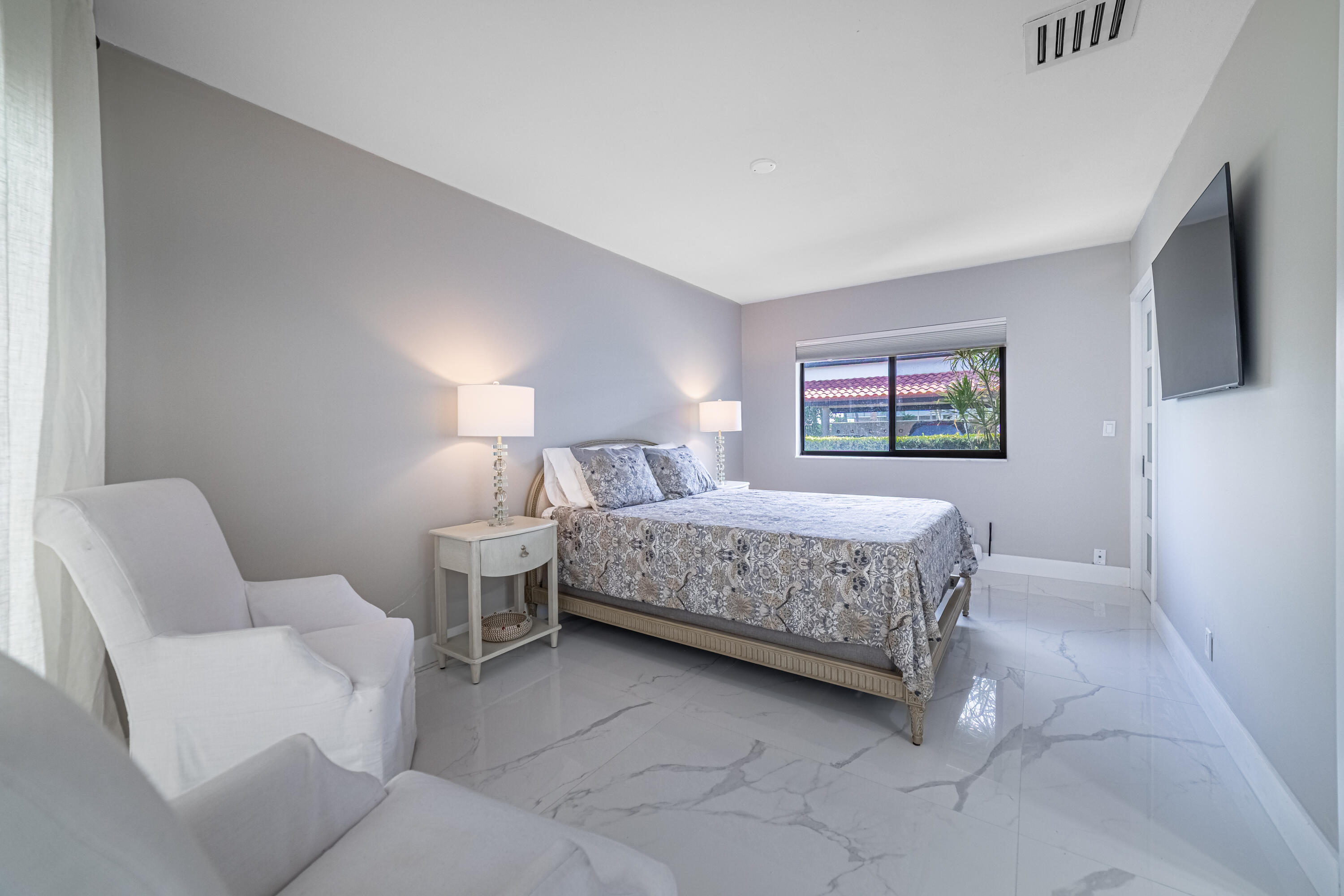 3474 South Ocean Boulevard, Unit 2 Palm Beach, FL 33480 - Photo 18 of 37 a bedroom with a bed and a couch