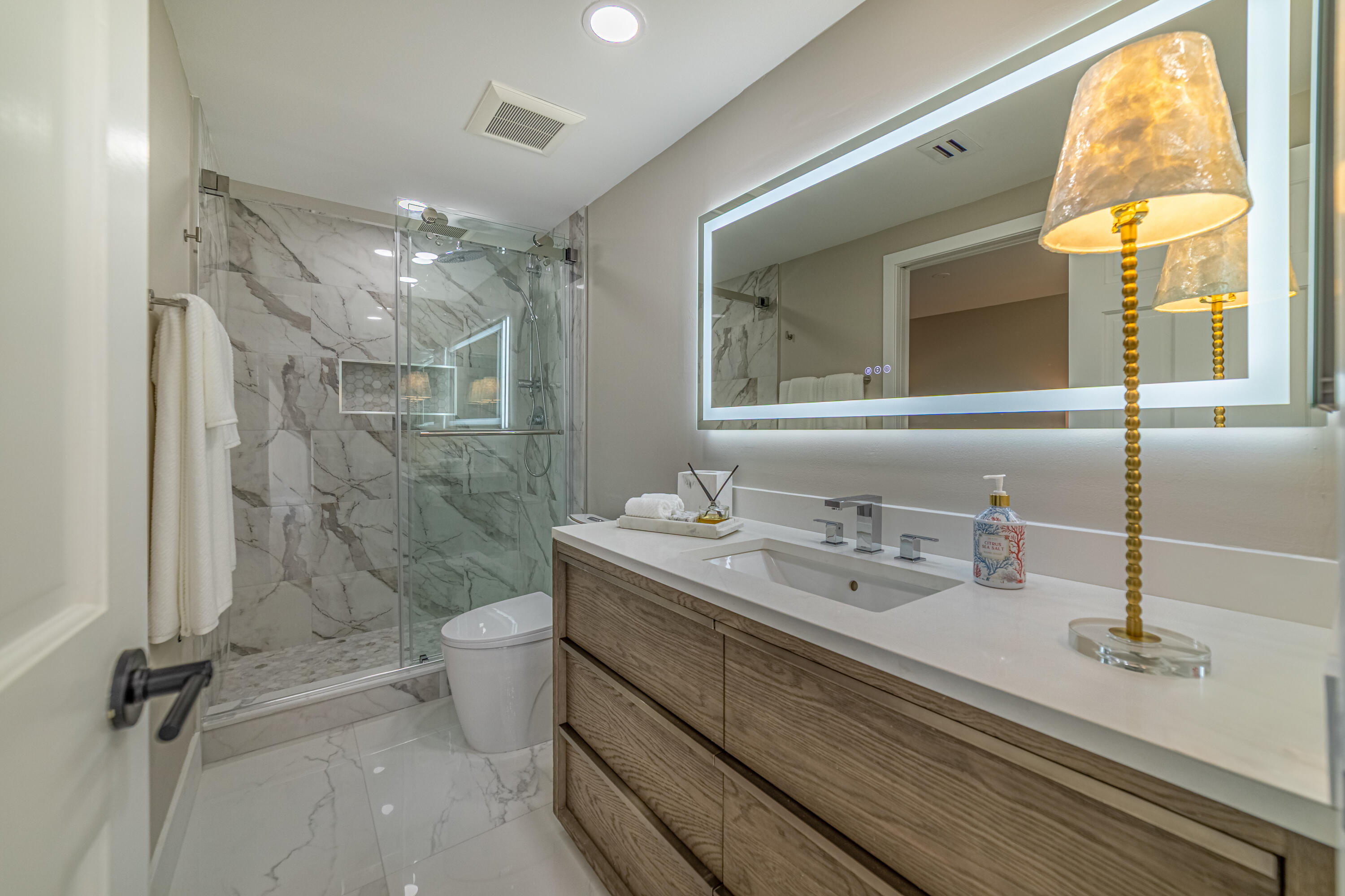 3474 South Ocean Boulevard, Unit 2 Palm Beach, FL 33480 - Photo 21 of 37 a bathroom with a double vanity sink toilet and a shower