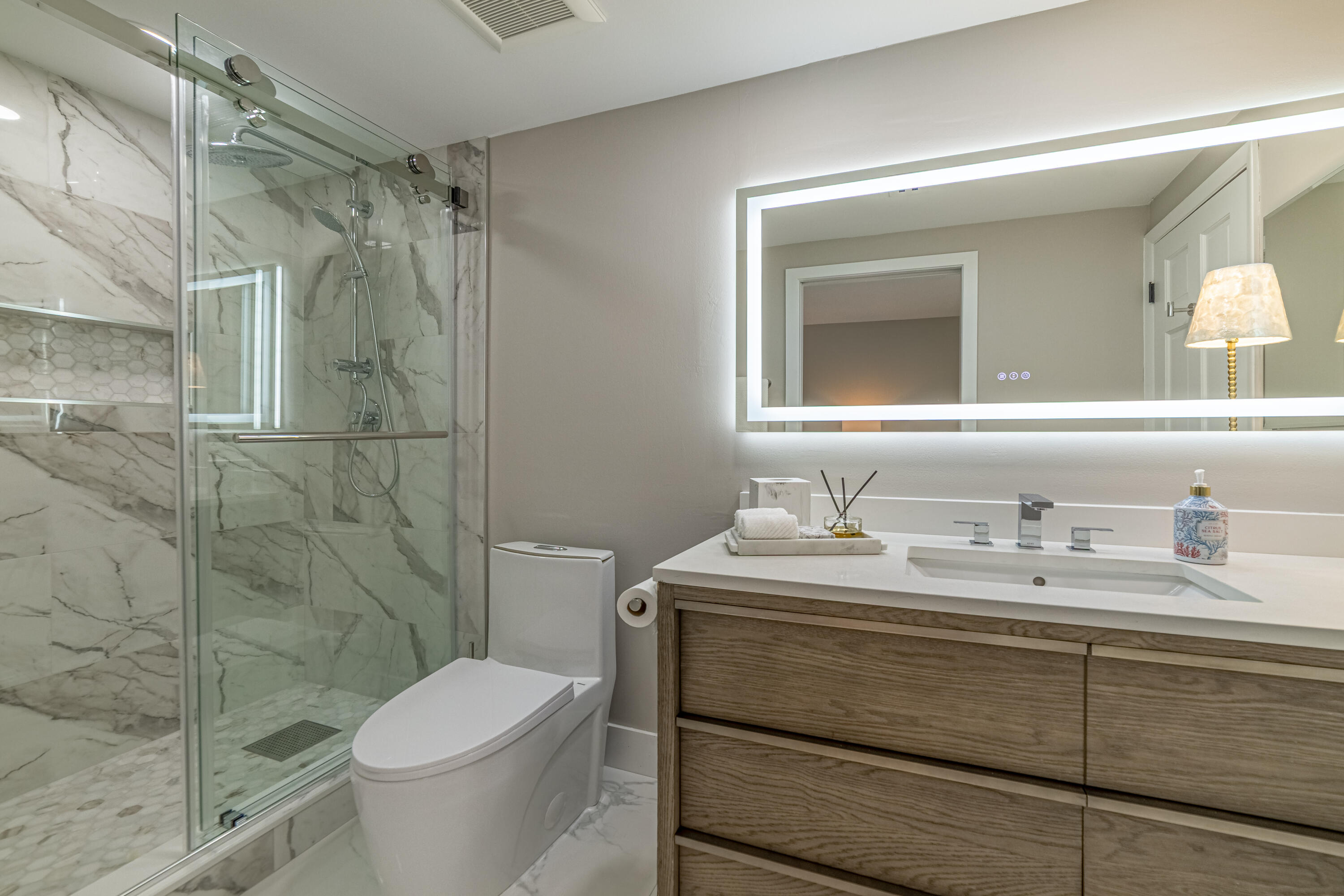 3474 South Ocean Boulevard, Unit 2 Palm Beach, FL 33480 - Photo 22 of 37 a bathroom with a granite countertop sink toilet a mirror and shower