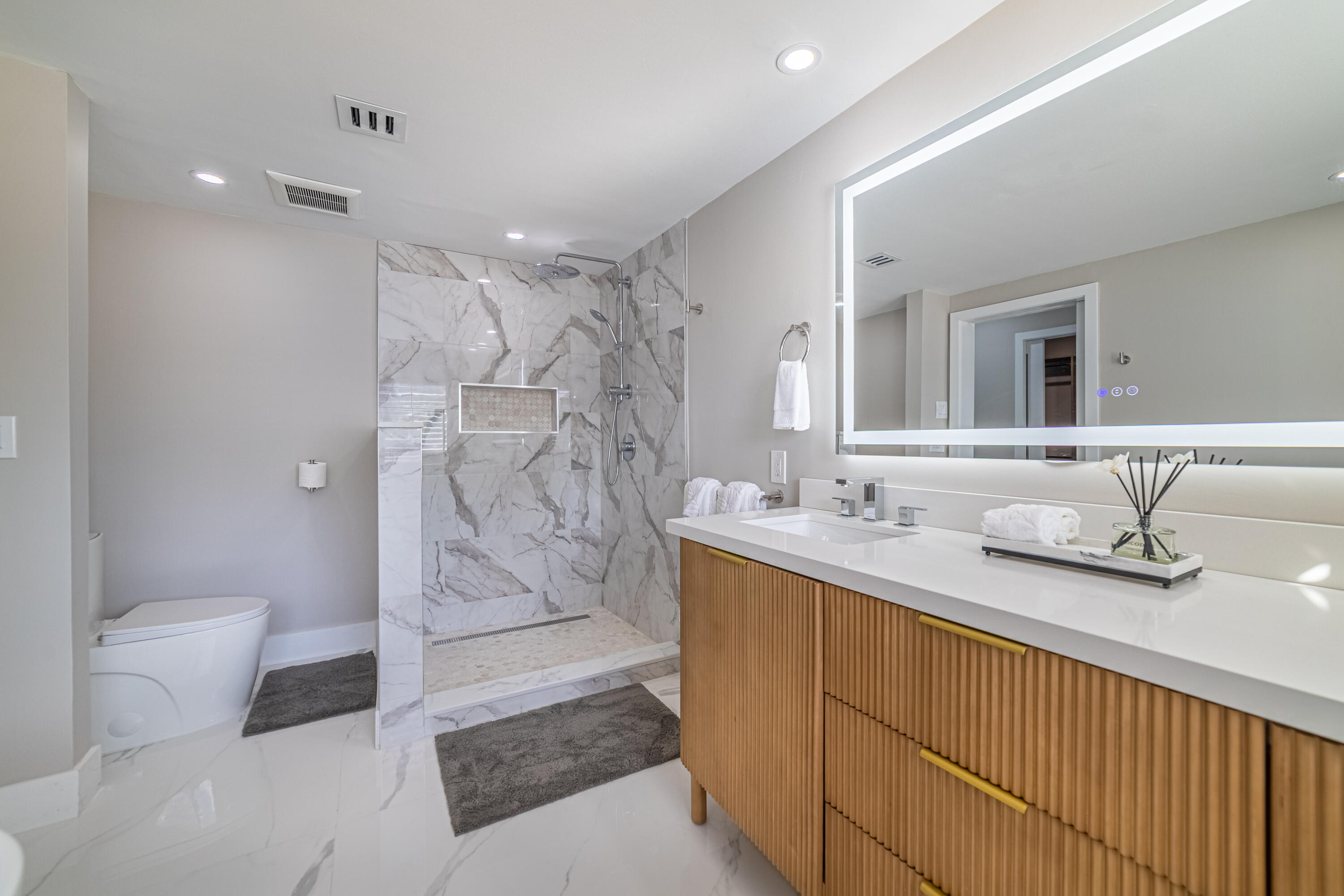 3474 South Ocean Boulevard, Unit 2 Palm Beach, FL 33480 - Photo 28 of 37 a bathroom with a granite countertop sink a toilet and shower
