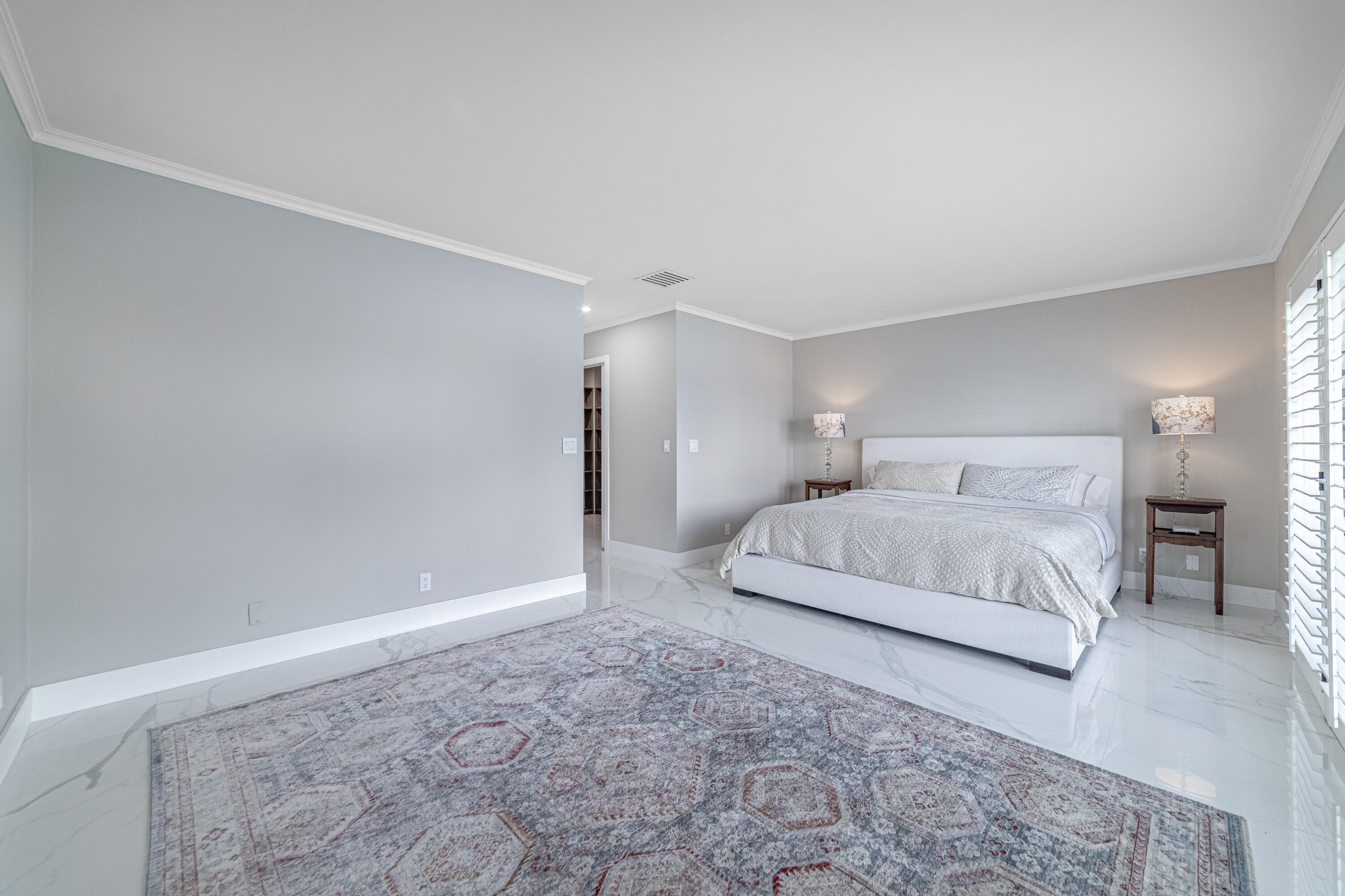 3474 South Ocean Boulevard, Unit 2 Palm Beach, FL 33480 - Photo 30 of 37 a spacious bedroom with a bed and a night stand