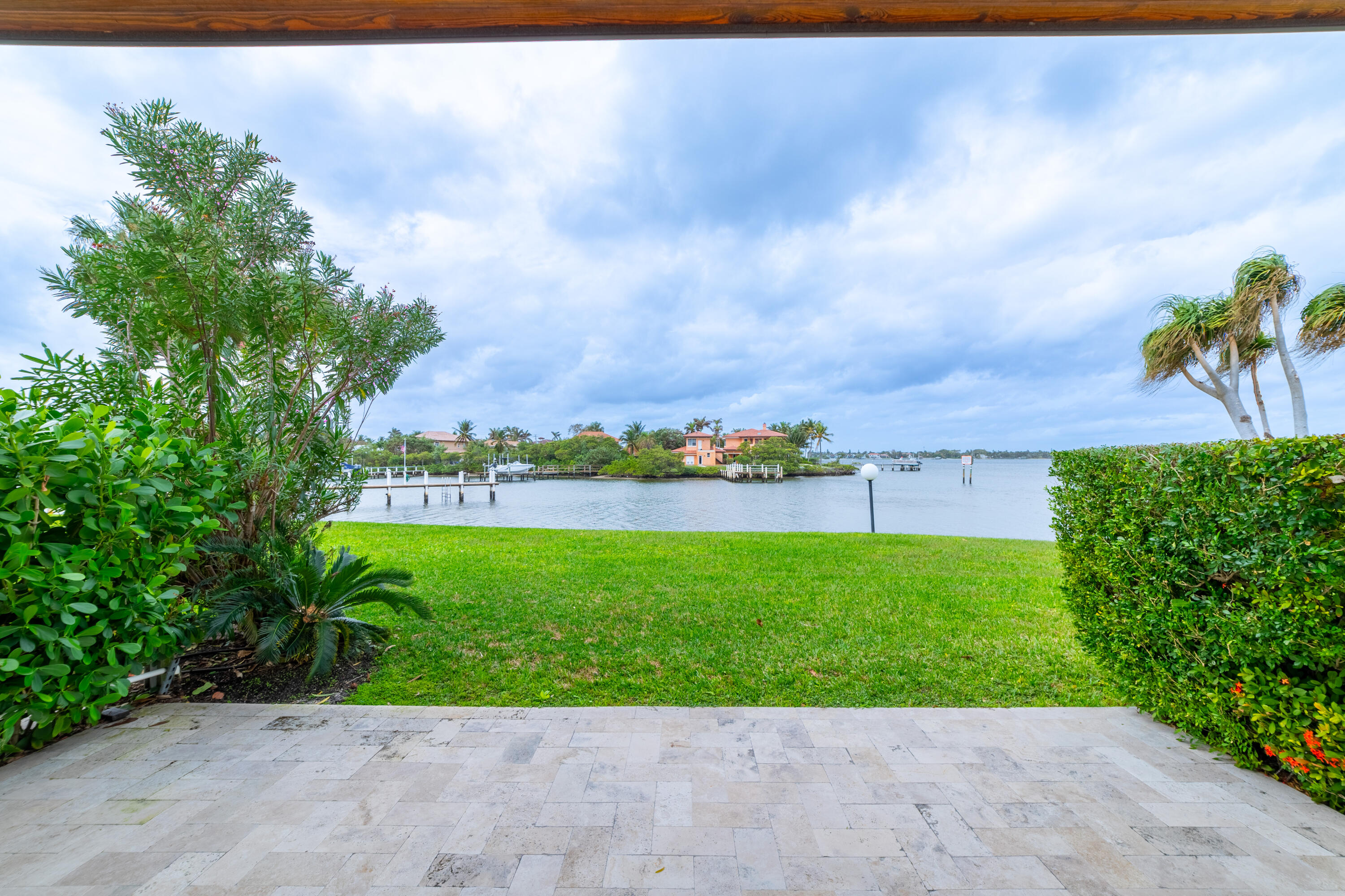 3474 South Ocean Boulevard, Unit 2 Palm Beach, FL 33480 - Photo 6 of 37 a view of a garden with a bench in back