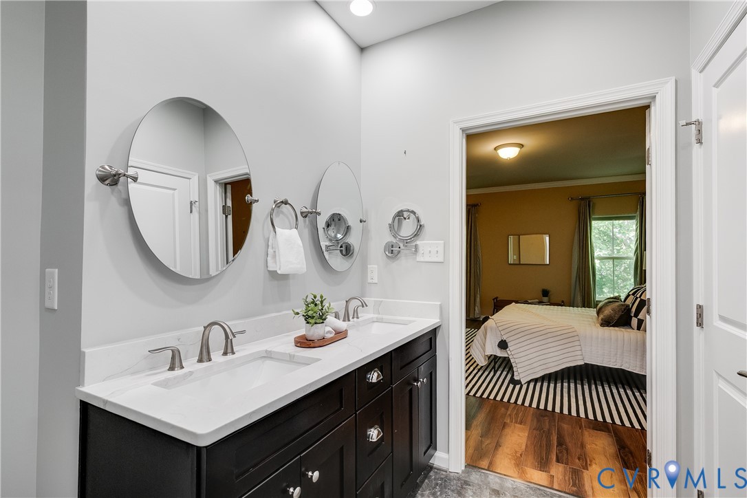 7538 South Franklins Way Quinton, VA 23141 - Photo 27 of 48 a bathroom with a sink a mirror and a lamp