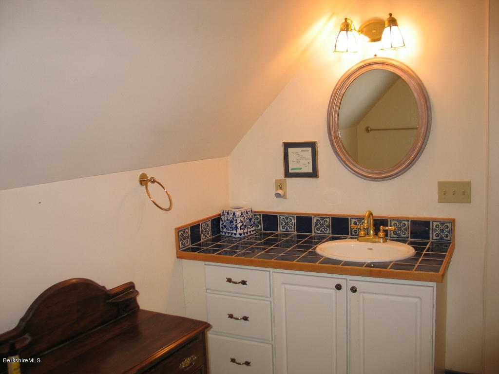 720 Hancock Road Williamstown, MA 01267 - Photo 14 of 24 a bathroom with a sink and a mirror