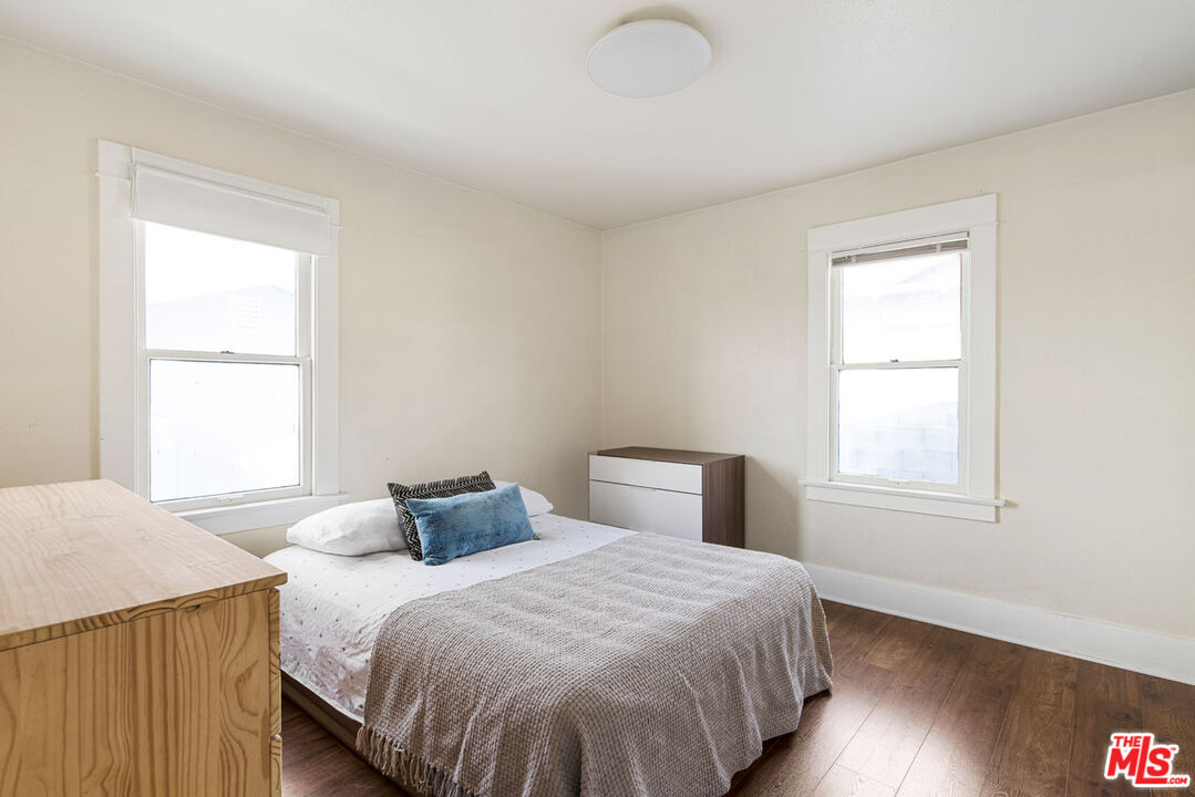 735 Orme Avenue Los Angeles, CA 90023 - Photo 14 of 33 a bedroom with a bed and wooden floor