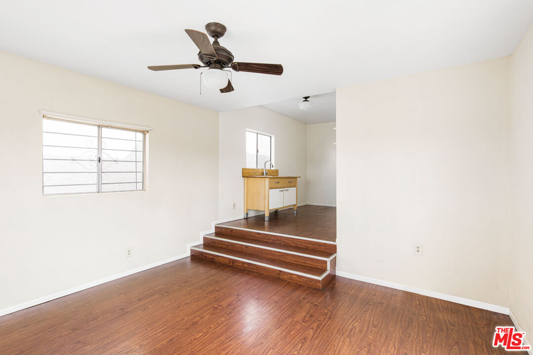 735 Orme Avenue Los Angeles, CA 90023 - Photo 19 of 33 a view of room with stairs and wooden floor