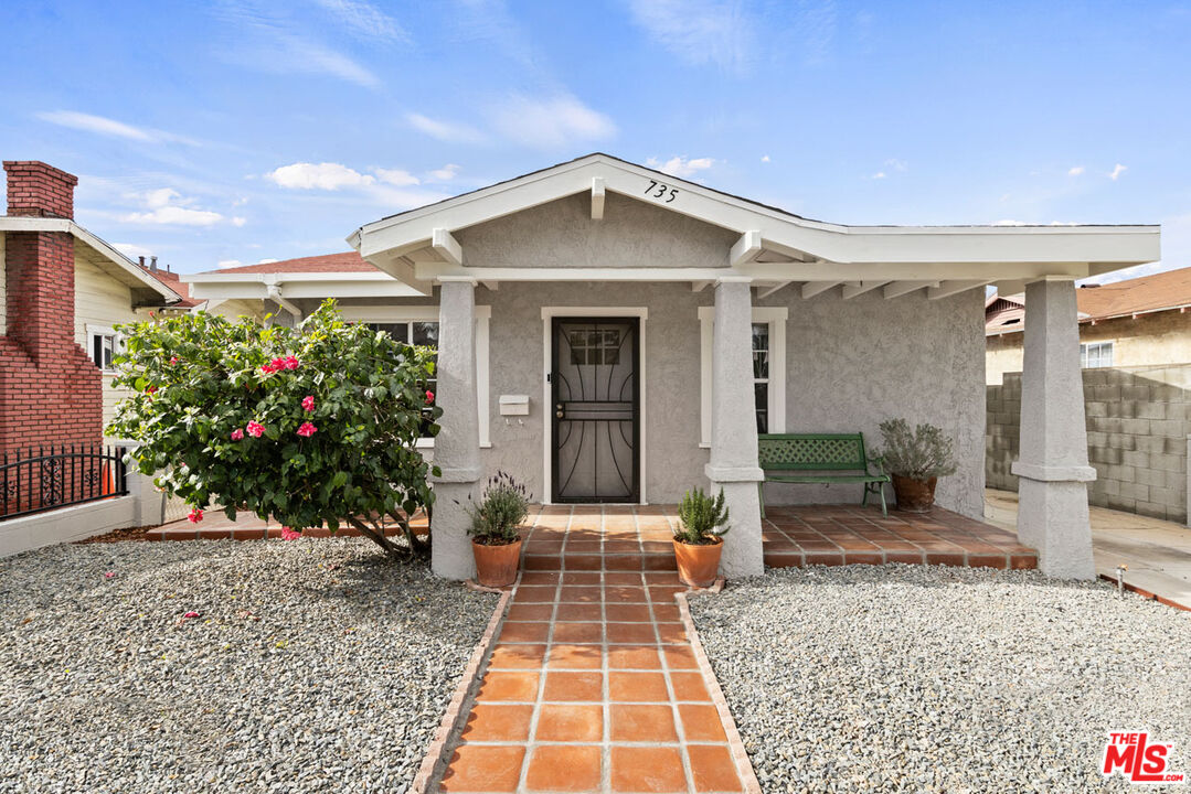 735 Orme Avenue Los Angeles, CA 90023 - Photo 2 of 33 a front view of a house with a yard