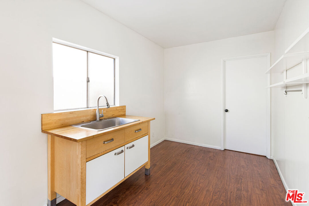735 Orme Avenue Los Angeles, CA 90023 - Photo 22 of 33 a kitchen with a sink cabinets and wooden floor