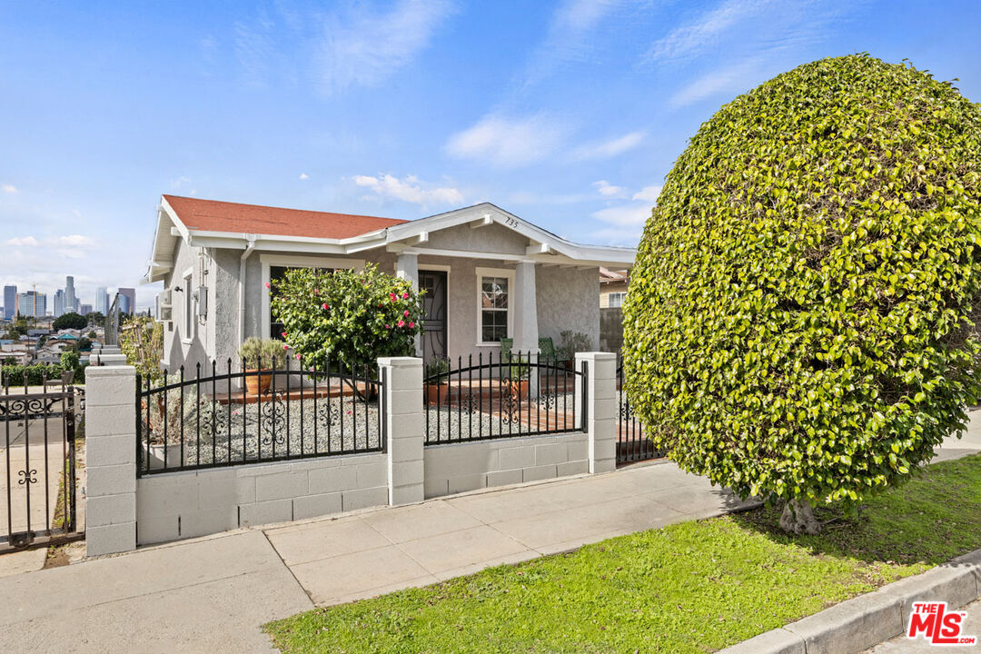 735 Orme Avenue Los Angeles, CA 90023 - Photo 27 of 33 a front view of a house with a garden