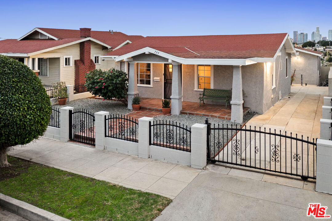 735 Orme Avenue Los Angeles, CA 90023 - Photo 29 of 33 a view of a house with wooden fence and a porch
