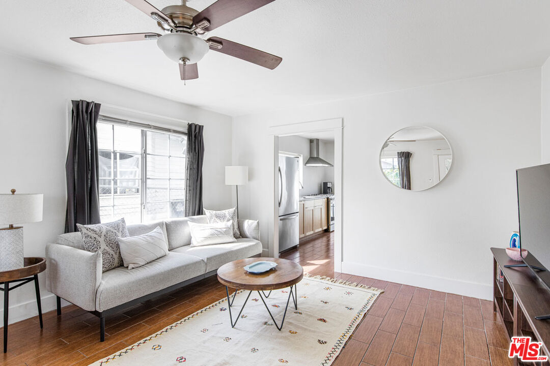 735 Orme Avenue Los Angeles, CA 90023 - Photo 4 of 33 a living room with furniture and a wooden floor