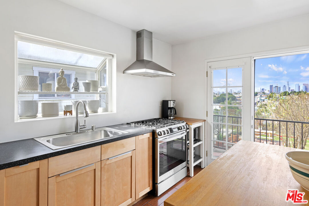 735 Orme Avenue Los Angeles, CA 90023 - Photo 8 of 33 a kitchen with a stove a sink and a window