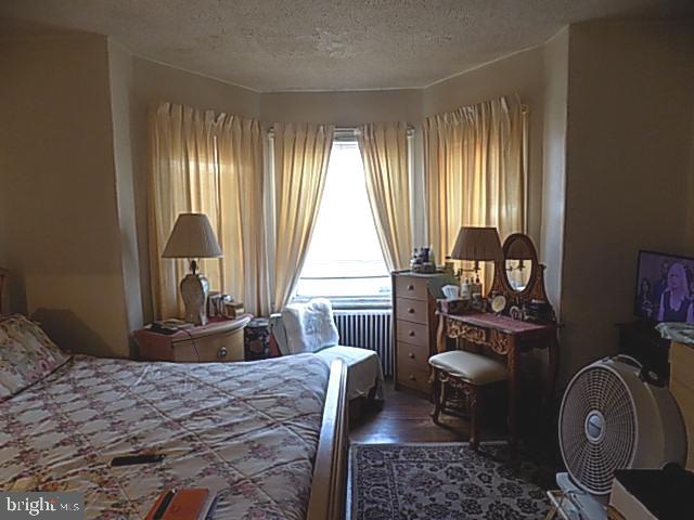 838 South 56th Street Philadelphia, PA 19143 - Photo 17 of 29 a bedroom with a bed and wooden floor