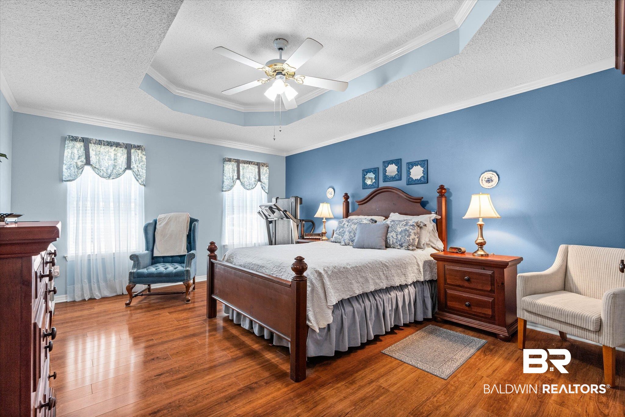 25825 Austin Road Daphne, AL 36526 - Photo 10 of 30 Bedroom featuring ornamental molding, a raised ceiling, wood finished floors, a ceiling fan, and a textured ceiling